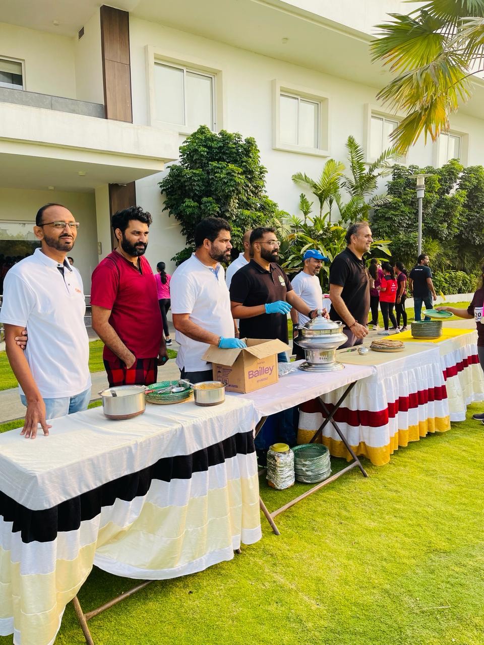 Volunteers preparing and serving food at annadanam tables during a community event