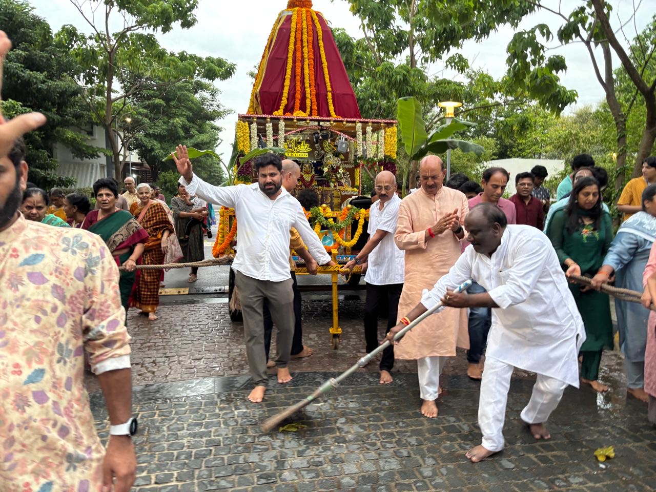 Residents gathered around a decorated temple chariot during a community cultural procession