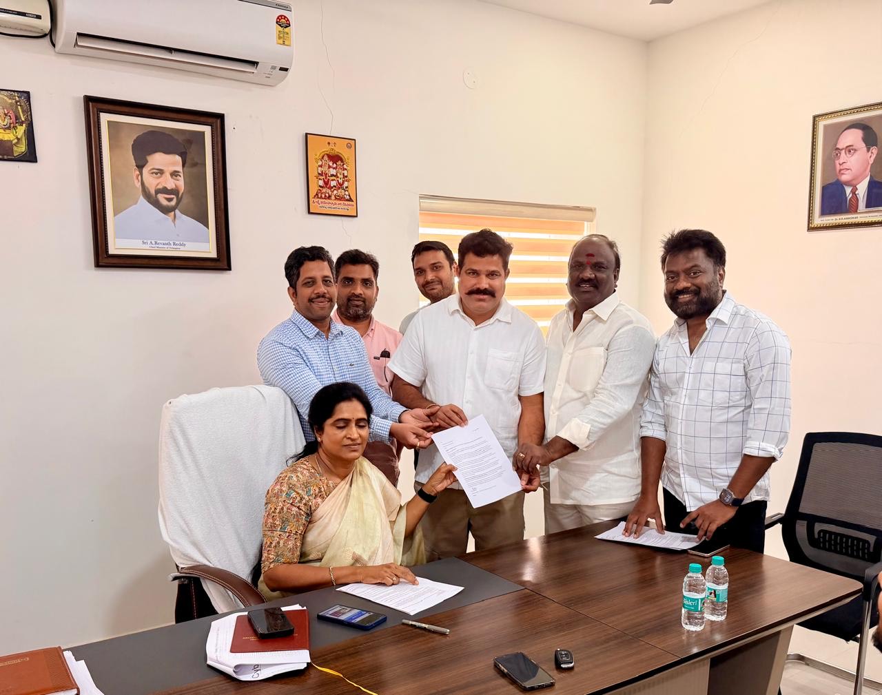 Service4Society representatives handing a written representation to a government official across an office table